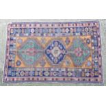 Carpet / Rug : A red ground kilim rug decorated with geometric motifs on blue , yellow , green