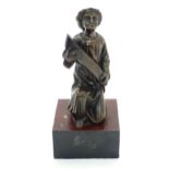 A 20thC cast bronze model of a classical figure kneeling with a large scroll. Approx. 7" high