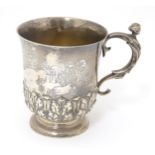 A silver mug with caryatid detail to handle and banded acanthus leaf. hallmarked London 1910,