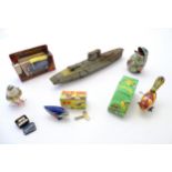Toys: A quantity of assorted tinplate toys to include a model of the battle ship HMS Edinburgh by
