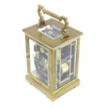 A French brass carriage clock / timepiece with 5 glass and white enamel face, with red/brown leather