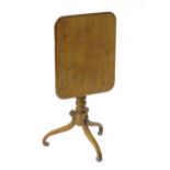 A mid 19thC mahogany tilt top occasional table with a rectangular moulded top above a turned