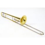 Musical Instrument: a Yamaha model YSL354 trombone, with fitted ABS case, approximately 45" long