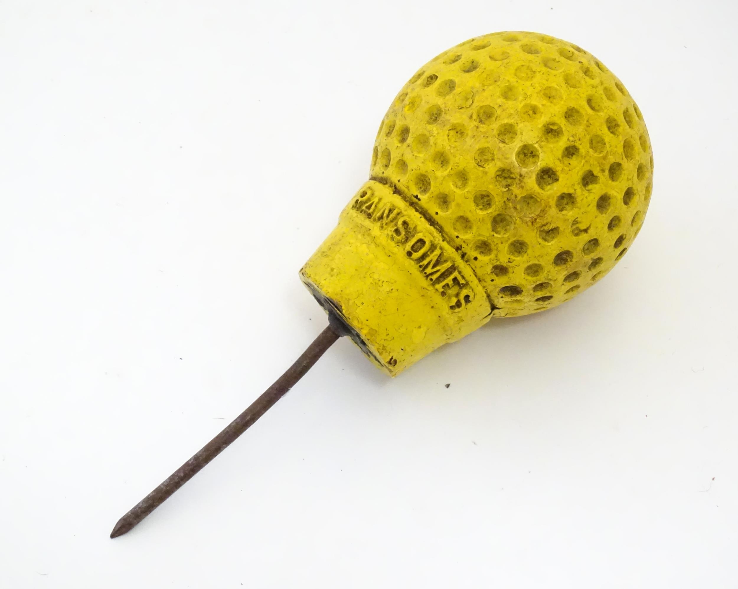 A 20thC novelty golf ball and tee advertising Ransomes - agricultural machinery makers. Approx.