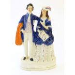 A large Victorian Staffordshire pottery flat back figural group depicting a young couple, possibly