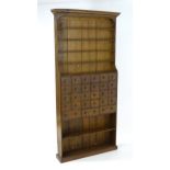 A late 18thC / early 19thC oak apothecary / chemist cabinet with a moulded cornice above five reeded