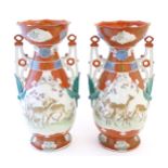 A pair of Japanese vases with flared scallop edge rims and twin pierced handles with relief