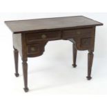 A 19thC continental desk with a crossbanded overhanging top above four short drawers and raised four