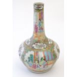 A Chinese / Cantonese bottle vase with panelled decoration depicting figures on a garden terrace,