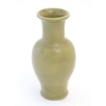 A Chinese stoneware baluster vase with a crackle glaze. Approx. 13 1/2" high Please Note - we do not