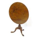 A mid / late 18thC mahogany tripod table with a circular top above a turned pedestal base and