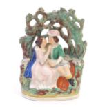 A Victorian Staffordshire pottery flat back figural group depicting Romeo and Juliet within a