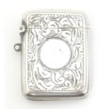 A silver vesta case with engraved acanthus scroll decoration, with striker under and hinged lid,