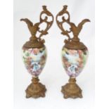 A pair of hand painted glass ewers with gilt metal mounts. Approx. 21" high (2) Please Note - we
