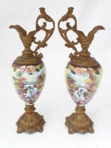 A pair of hand painted glass ewers with gilt metal mounts. Approx. 21" high (2) Please Note - we