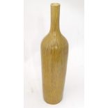A large stoneware bottle vase with vertical detail. Approx 30 1/2" high Please Note - we do not make