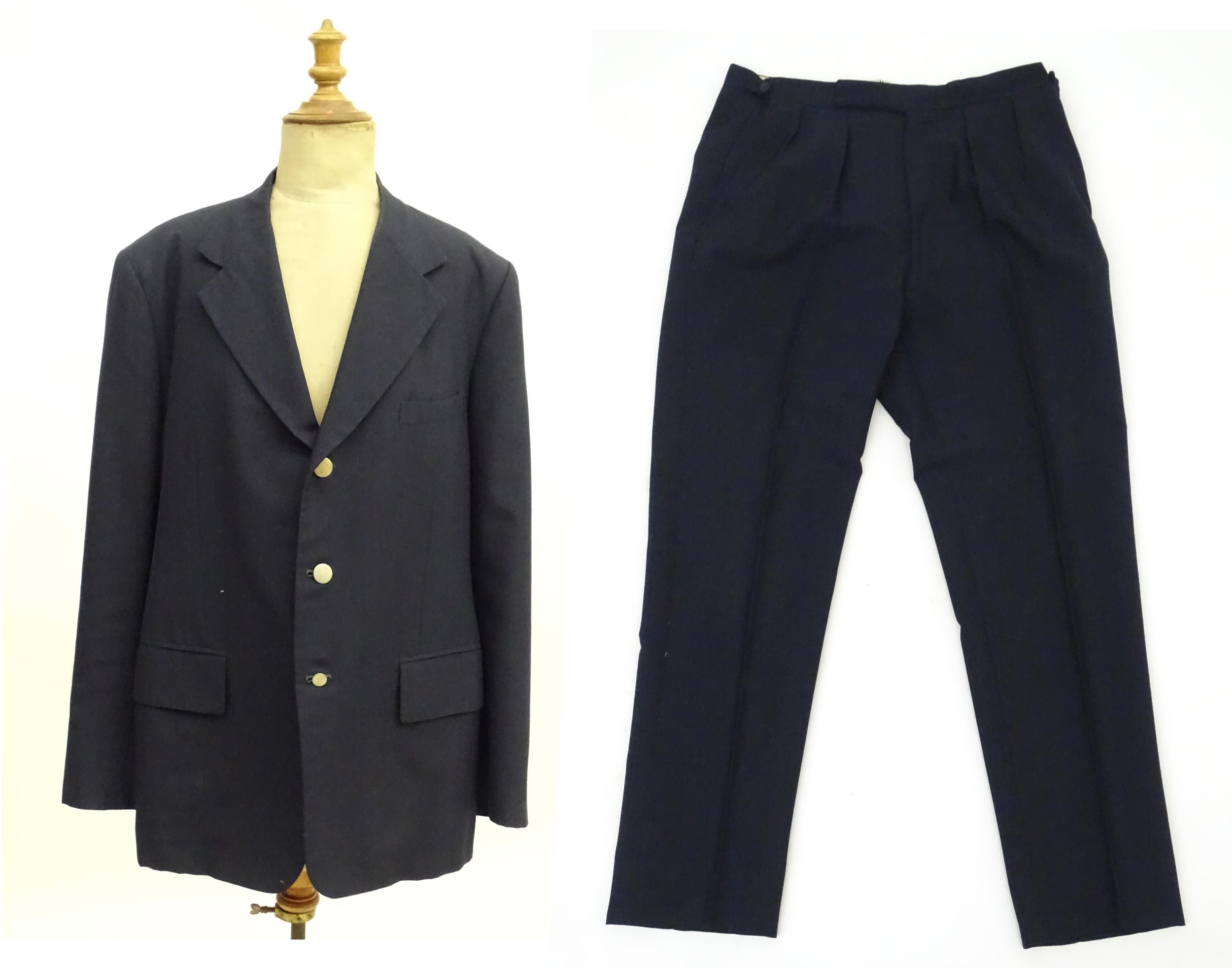 A navy blue bespoke suit with tapered trousers and metal button detail by 'Sam's Tailor' based in