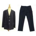 A navy blue bespoke suit with tapered trousers and metal button detail by 'Sam's Tailor' based in
