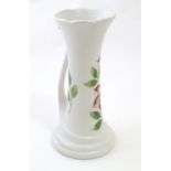 An Art Nouveau E Radford hand painted jug / vase with a tendril formed handle and hand painted