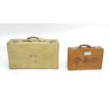 A mid 20thC velum bound suitcase, together with a smaller tan leather case, each with partial