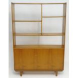 A Vintage / Retro teak room divider / cabinet with five shelves above two cupboards with shaped