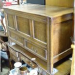 A 20thC oak panelled coffer with lifting top and two drawers under. Approx. 39 1/2" wide x 19 3/4"