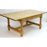 A late 20thC pine kitchen table with a large rectangular top above a peg jointed base with four