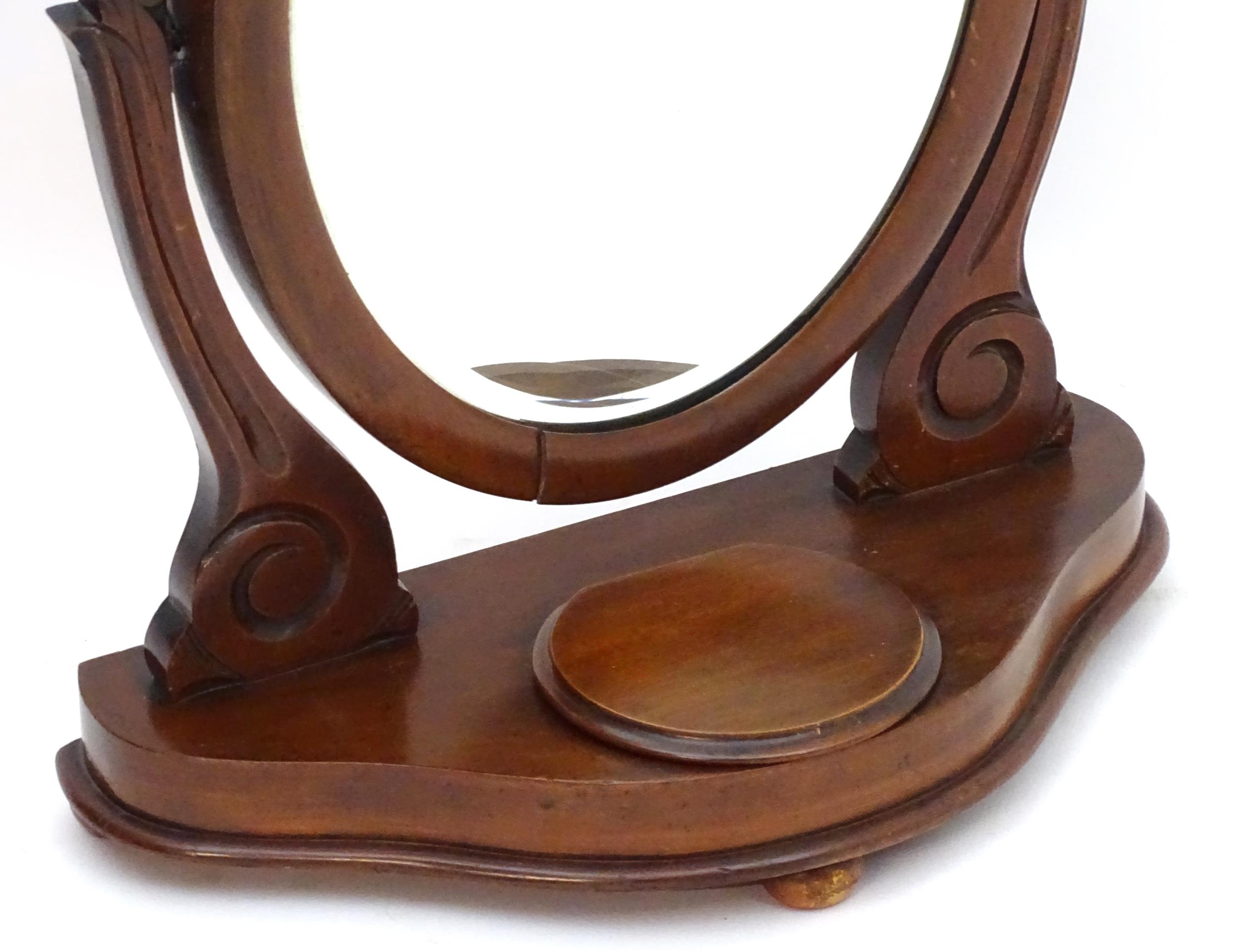 A Victorian mahogany toilet mirror with an oval mirror and shaped surrounds above a moulded base - Image 6 of 6