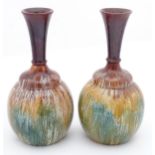 A pair of ceramic bottle vases with flared necks and drip glaze. Approx 9 1/2" high Please Note - we