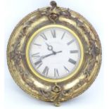 A circular wall clock with a quartz movement and gilt surround, the printed dial marked Edinburgh
