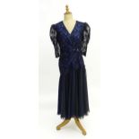 Vintage clothing / fashion: A c1980s navy and black wrap style dress with a drop waist and puffed