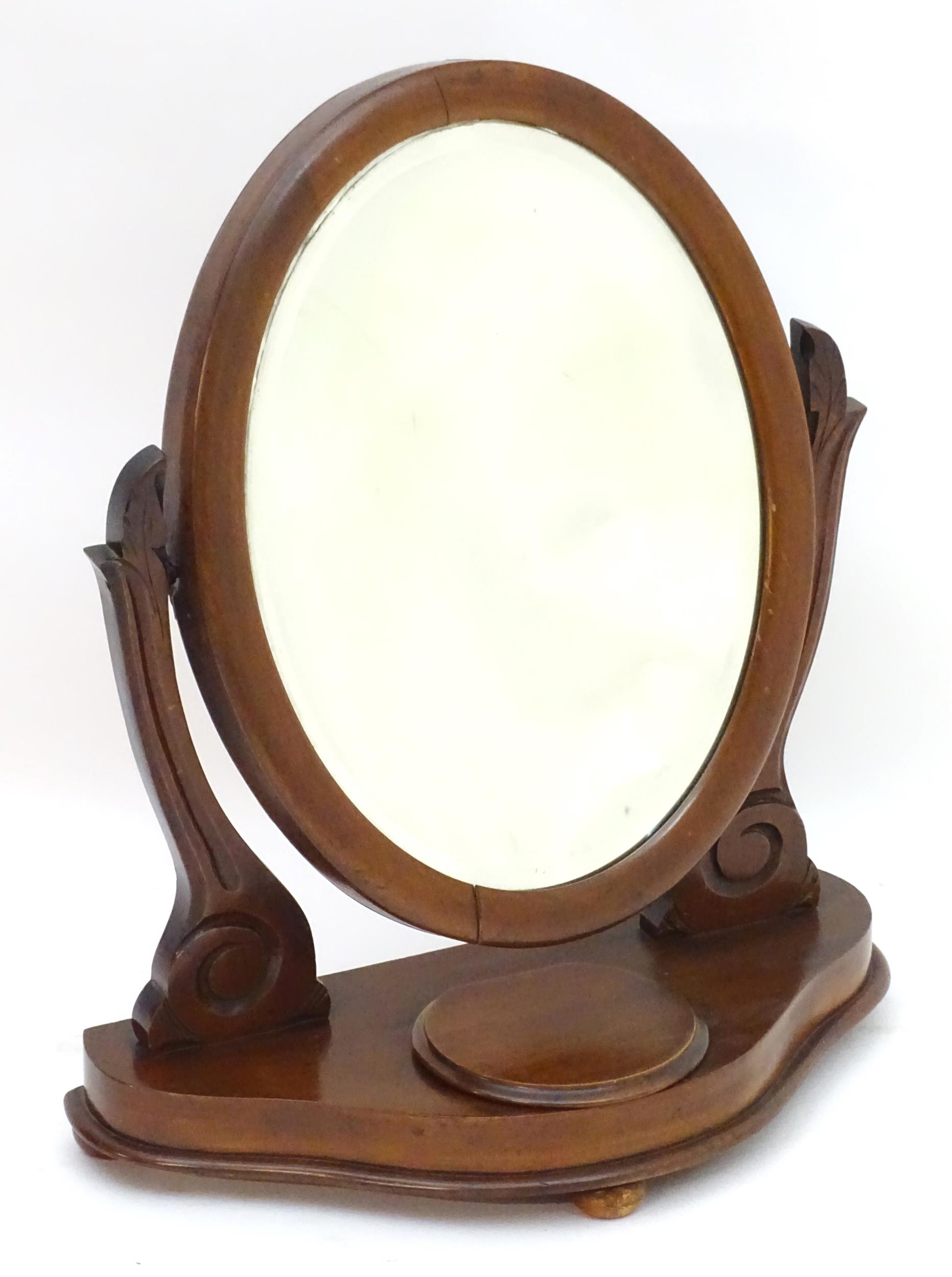 A Victorian mahogany toilet mirror with an oval mirror and shaped surrounds above a moulded base - Image 3 of 6