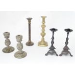 A quantity of assorted candlesticks examples to include brass, turned wooden, etc. Please Note -