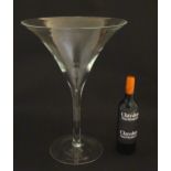 A large glass formed as an oversized Martini cocktail glass, possibly for shop / bar top display.
