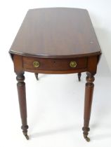 A mahogany drop leaf table. Approx. 24" long Please Note - we do not make reference to the condition