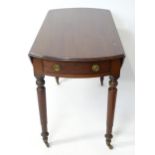 A mahogany drop leaf table. Approx. 24" long Please Note - we do not make reference to the condition