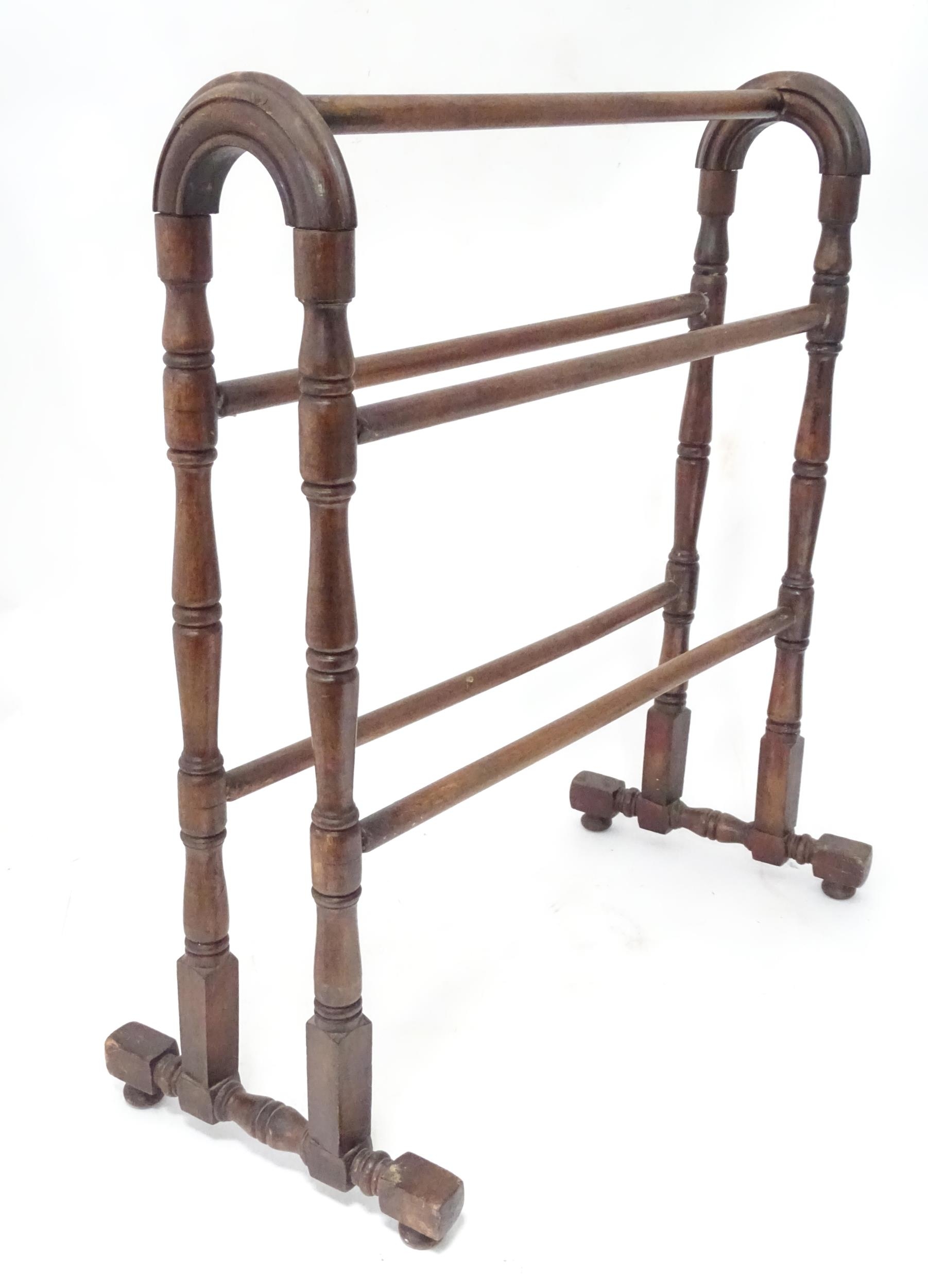A stained pine towel rail. Approx. 26" wide x 13" deep x 30 1/3" high Please Note - we do not make