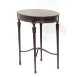 A 20thC mahogany oval occasional table with four carved legs. Top approx. 27" x 18 1/2", x 27 1/2"