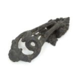 A cast door knocker of scrolling form. Approx. 8 1/4" long Please Note - we do not make reference to