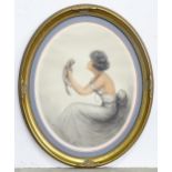 An oval limited edition print depicting a woman holding a small dog, facsimile signature for J