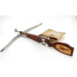 A crossbow made by R A Ekins & Son of Surrey, with box. The stock with inlaid grouse and owl detail.