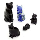 Four ceramic models of cats, together with a small novelty teapot modelled as a black cat. Largest