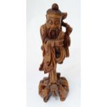 An Oriental carved hardwood figure modelled as a sage. Approx. 14 1/2" high Please Note - we do