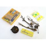 An assortment of fishing equipment, including a vintage 2 3/4" centrepin reel, wire traces, plugs,