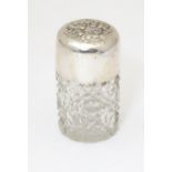 A cut glass scent bottle with silver lid having cherub decoration. Hallmarked Birmingham 1905.