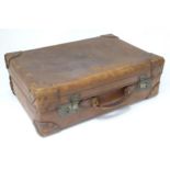 A leather suitcase with reinforced corners and brass locks Please Note - we do not make reference to