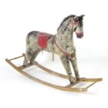 Toy: A 20thC plush rocking horse on bows with red and white saddle and reins. Approx. 38" high