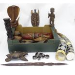 A quantity of assorted carved tribal items to include figures, spears, decorated ox horns etc. Horns