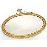 A 19thC oval mirror with gilt frame and bevelled glass. Approx. 28" wide x 25" high Please Note - we