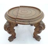 A low circular table / jardiniere stand standing on four lions paw feet. The top approx. 21"